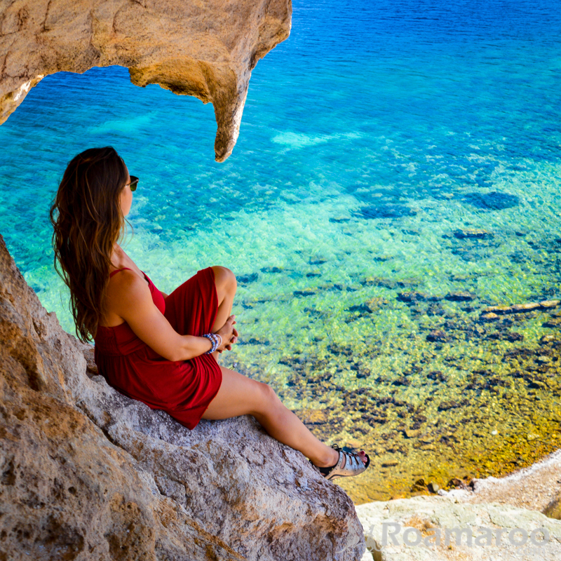 lightly dressed traveler on cliff